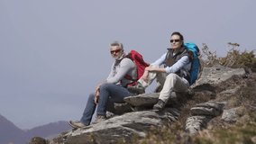 Hikers admiring mountain scenery during trekking day
