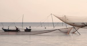 Vietnamese fishermen sets the big casting net in a fishing village near Hoi An.