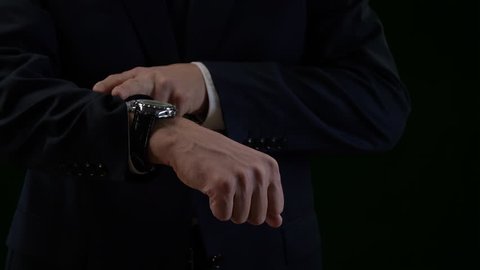 Close up luxury watch on male hand isolated on black background