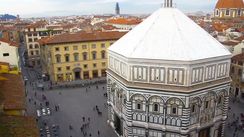Tourists are walking in the center of Florence. Top view of the square in front of the Battistero di San Giovanni