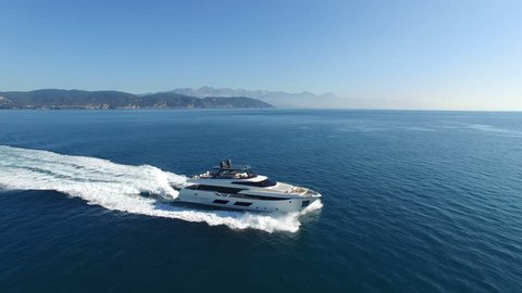 Aerial view of a luxury yacht sailing.