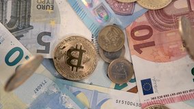 Virtual cryptocurrency money Bitcoin golden coins on European Union EU Euro 5, 10 and 20 banknotes with Euro coins - 1 Euro and 50 cents. x5 slow motion fall. - Powered by Shutterstock - Get 15% off with code: PIKWIZARD15