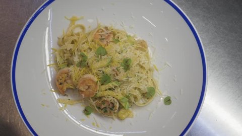 Pasta spaghetti with shrimps and white sauce, made by chef greens