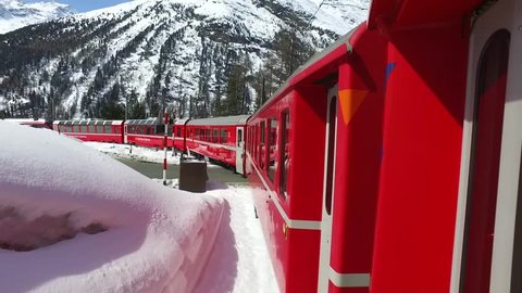 Red train of Bernina, mountain valley view from inside the train. Unesco World Heritage
