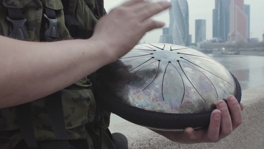 Playing Drum hapi in city close up