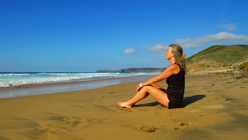 Sportive woman doing excersises on the beach