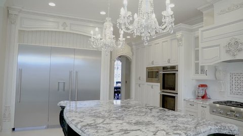 Luxurious white kitchen in a new home with a marble table