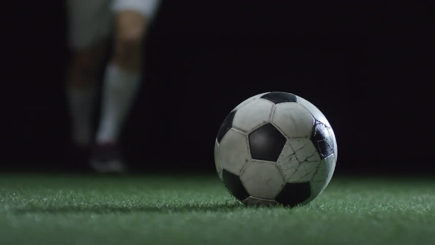 Closeup of soccer ball shoot by professional player on stadium field with artificial turf Royalty-Free Stock Footage #1010320124