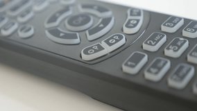 Channel changing on TV remote control close-up video