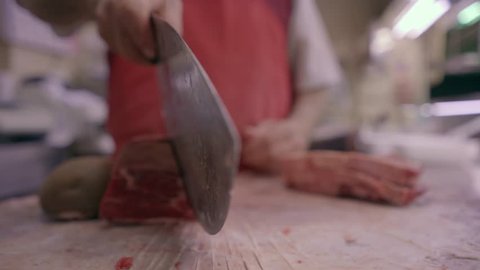 Butcher Cutting Raw Mea