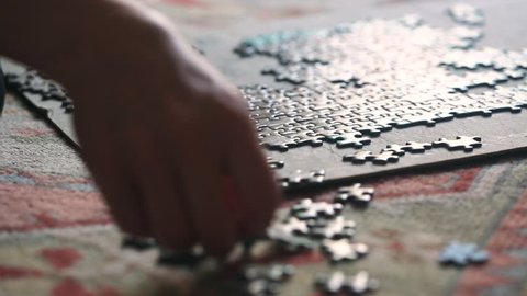 Woman trying to finish puzzle