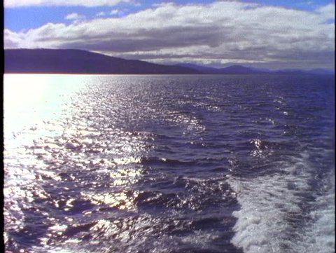 ARGENTINA, 1998, Crossing Andes mountain lake, POV from boat, the stern with wake