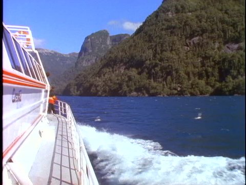 ARGENTINA, 1998, Crossing Andes mountain lake, POV from boat, side view of boat
