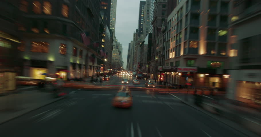 Time lapse of taxis and cars driving around New York Coty in the evening with light streaks. Royalty-Free Stock Footage #1010357051
