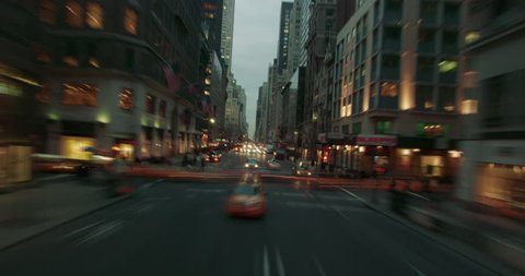 Time lapse of taxis and cars driving around New York Coty in the evening with light streaks.
