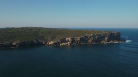 Aerial video of Manly North Head Harbour National Park with Sydney in the background on a beautiful sunny day.