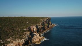 Aerial video of Manly North Head Harbour National Park with Sydney in the background on a beautiful sunny day.