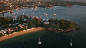 Aerial video of Watsons Bay with Sydney in the background during a beautiful sunset.
