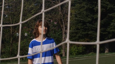 Slow motion of young boy heading football soccer scoring goal, 4k: stockvideo