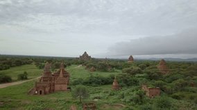 Drone shot aerial view of Bagan archeological zone with ancient temples buddhist religion in greenery landscape shot in 4K resolution October nature travel destinations concept 