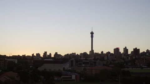 Johannesburg, Gauteng / South Africa - 04 24 2018: JOHANNESBURG, SOUTH AFRICA, 24 APRIL 2018 - A time-lapse of the sun rising over Hillbrow, Johannesburg on April 24th 2018.