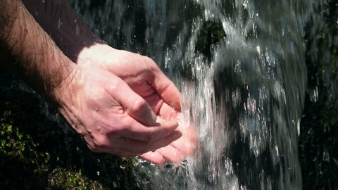 Cupped hands gathering fresh clean source water