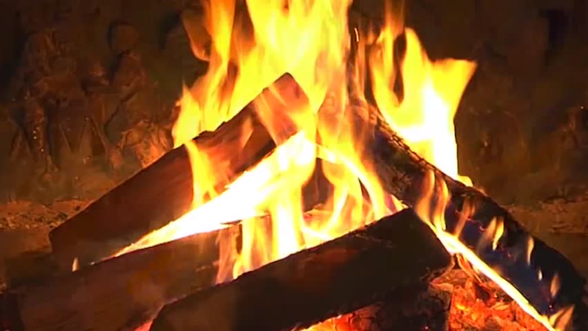 Excellent satisfying close up shot on wood burning slowly with orange fire flame in cozy brickwork fireplace atmosphere. Rural life. Burning chop wood in the stone fire-place from fire-bricks. 4K.