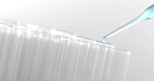 Pipette drips blue chemicals into a test tube 