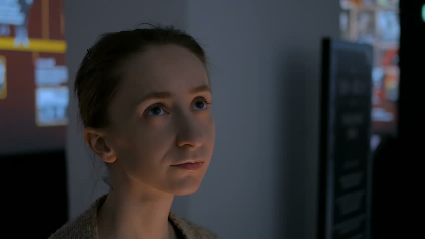 2 shots. Young woman looking around in modern historical museum. Evening time, lowlight. Education and entertainment concept