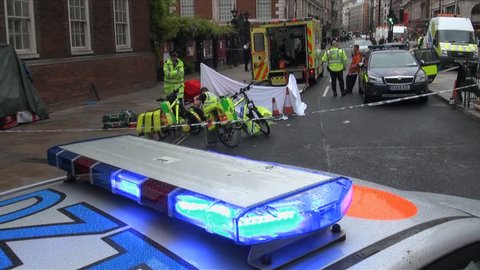 London, United Kingdom (UK) - 05 09 2012: Police guard crime scene where a dead man lies on a stretcher