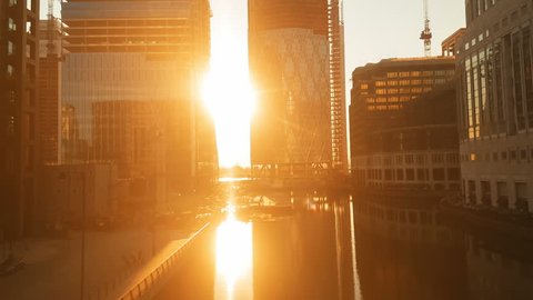 Spectacular tracking sunset shot in the Canary Wharf docklands district, the financial heart of London, England, UK