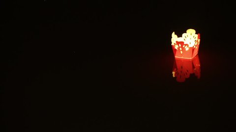 Floating Lantern Glides Past in Hoi An Vietnam