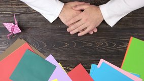 Man making yellow paper butterfly. Easy paper butterfly origami. Origami creativity workshop. - Powered by Shutterstock - Get 15% off with code: PIKWIZARD15
