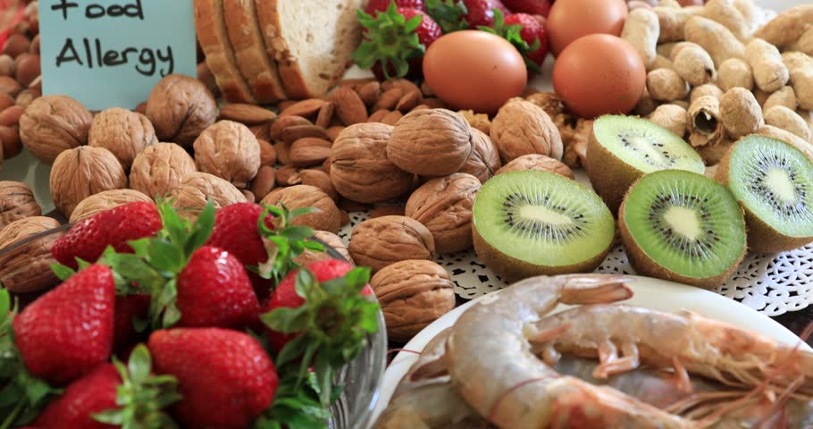Portrait of sad young boy with food allergy looking at the allergic food. Peple food and health care concepts.