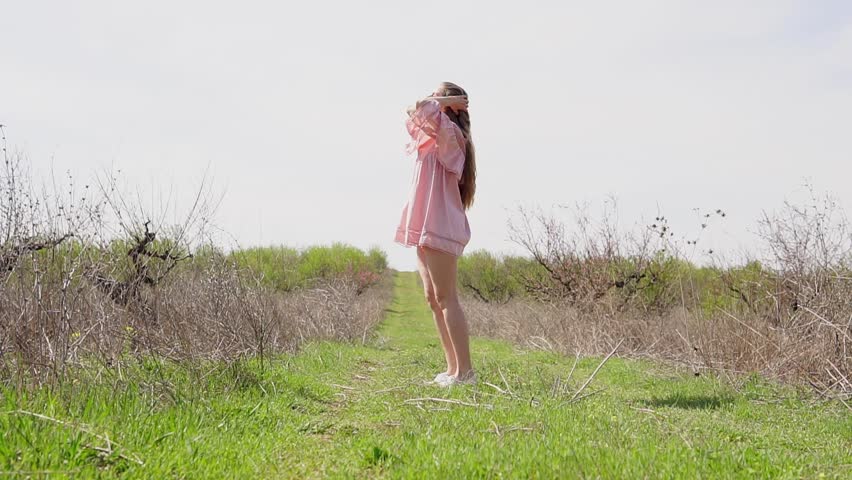 girl in pink dress posing in the garden