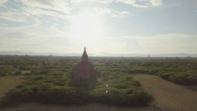 Drone shot aerial view of Bagan archeological zone with ancient temples buddhist religion in greenery landscape shot in 4K resolution October nature travel destinations concept 