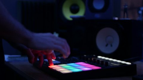 Producer making music with digital audio workstation beatmaker in professional studio