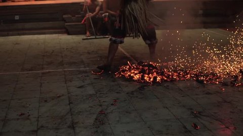 Bali, Indonesia Fabruary 3, 2018: Balinese Kecak Dance, known as the Ramayana Monkey Chant and Fire Dance at temple in Ubud Village on Bali, Indonesia. Old an walks with his bare feet on the coals