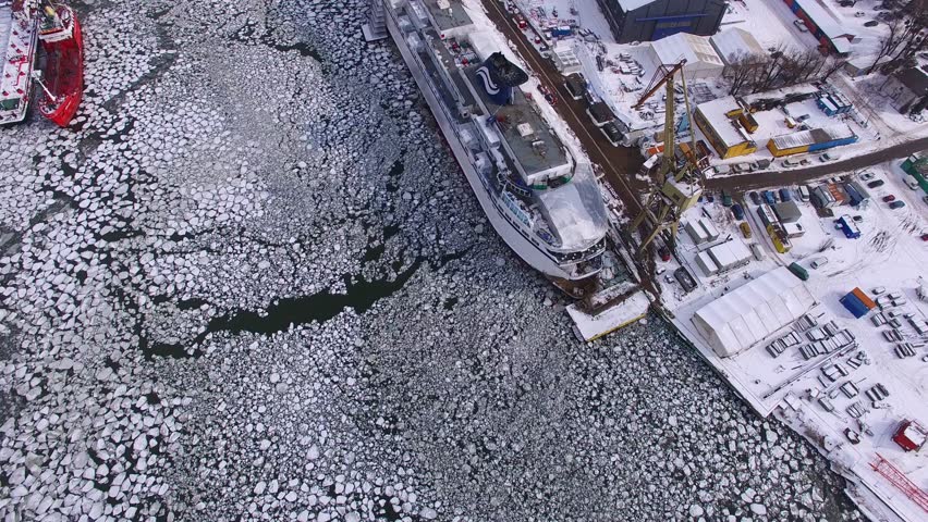 Aerial of Shipyard on Frozen River with Ice Floes in Winter