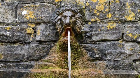 Lion Head Wall Water Fountain in the Chalice Well Garden, Glastonbury, England, United Kingdom, Europe