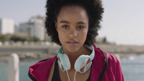 portrait of attractive african american woman in sportswear posing confident on sunny beachfront looking pensive thoughtful - Powered by Shutterstock - Get 15% off with code: PIKWIZARD15