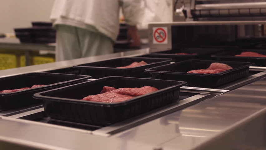 Meat processing in food industry,Packaging meat on the production line at the factory  Royalty-Free Stock Footage #1010444738
