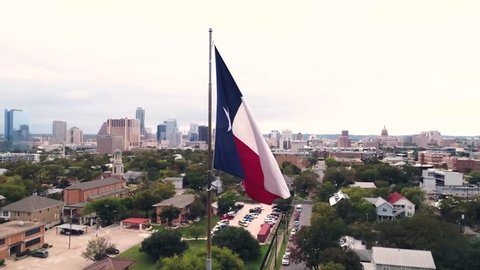 4K Texas Flag Orbiting Aerial at Sunset Austin