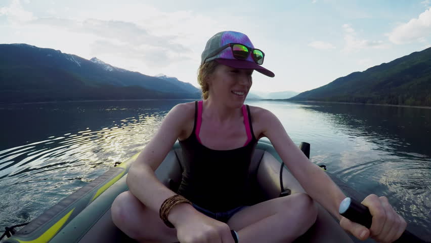 Young woman sailing boat in the river on a sunny day 4k