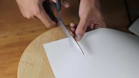 Cutting paper with scissors video