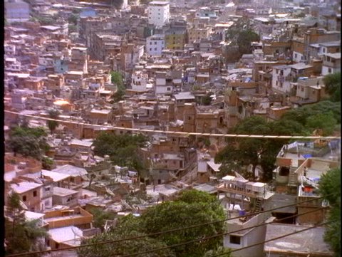 BRAZIL, 1998, Slums of Rio de Janeiro, favelas, on hillside, tilt up to luxury towers