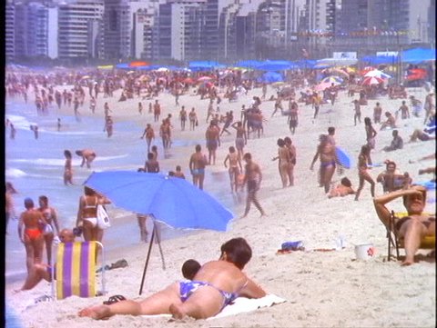 BRAZIL, 1998, Rio de Janeiro, Copacabana beach, people on the beach, vendor passes