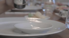 Person dumps soy sauce in a plate. Slow-Motion. RAW edited video.