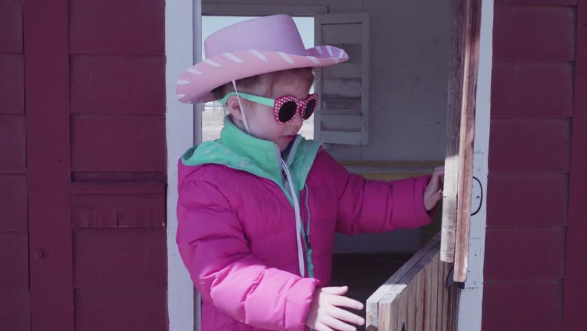 Little girl playing on playground at the urban farm.