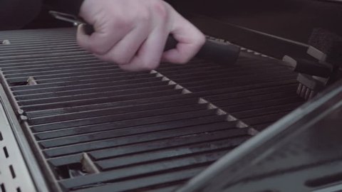 Cleaning gas grill before cooking.